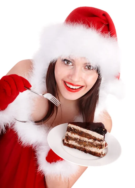 Natale ragazza in cappello di Babbo Natale mangiare torta sul piatto . — Foto Stock