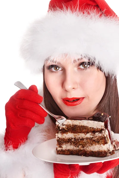 Weihnachtsmädchen mit Weihnachtsmütze essen Kuchen . — Stockfoto