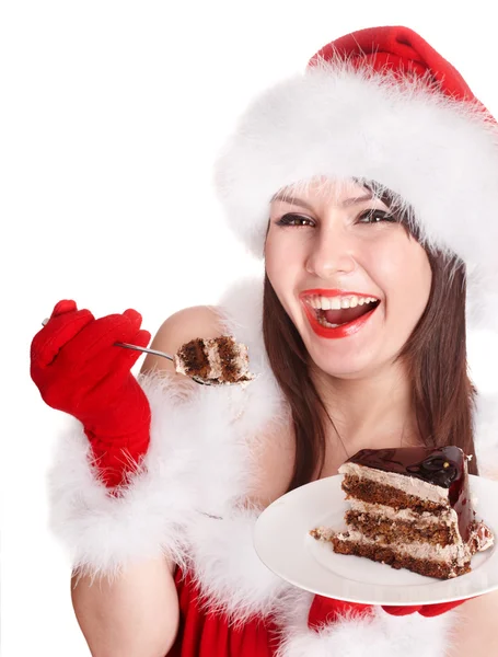 Weihnachtsmädchen mit Weihnachtsmütze essen Kuchen . — Stockfoto