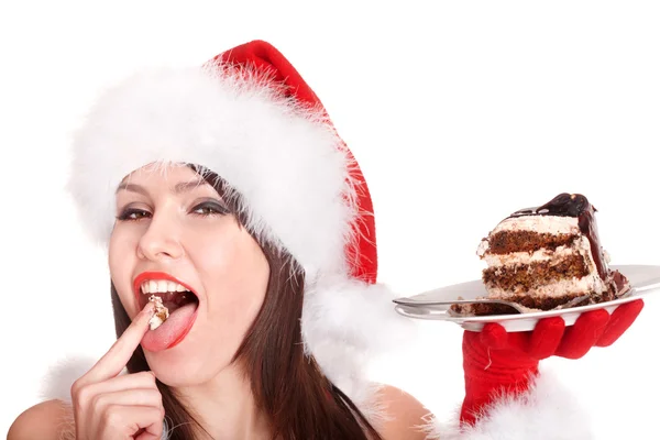 Menina de Natal em santa chapéu comer bolo  . — Fotografia de Stock