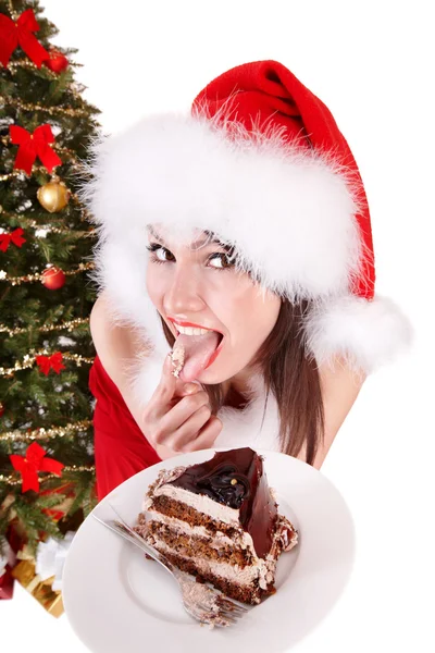 Noel Baba şapkalı kız Noel kek yemek . — Stok fotoğraf