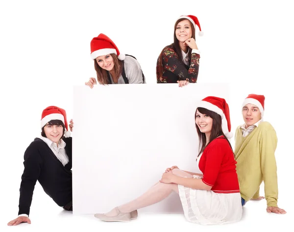 Happy group in santa hat whith banner. — Zdjęcie stockowe
