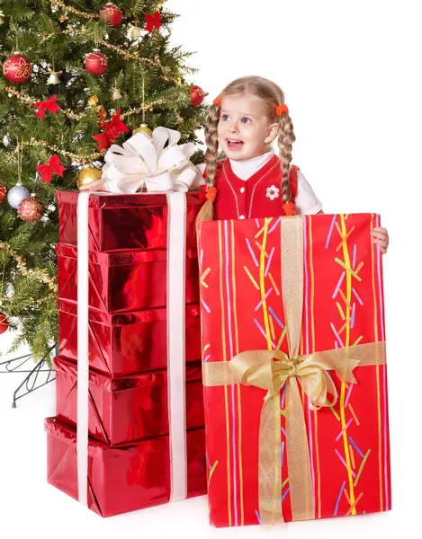 Kind houden doos van de gift door kerstboom. — Stockfoto