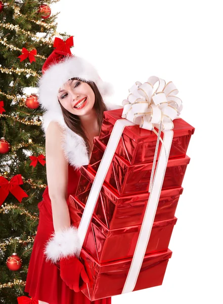 Girl in santa hat giving stack red gift box. Royalty Free Stock Images