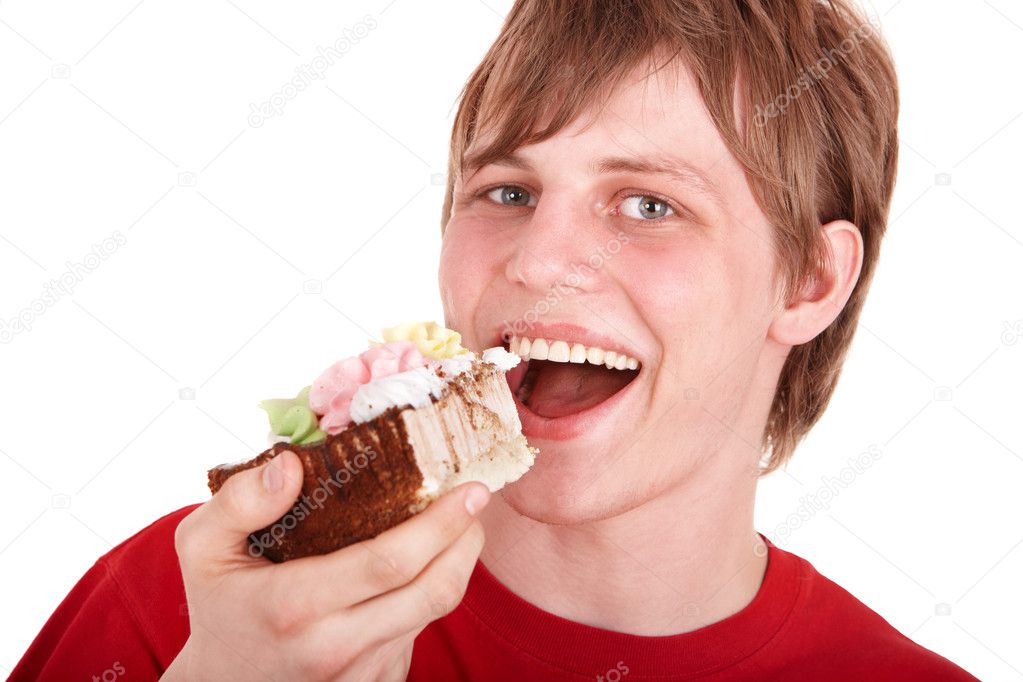 Young man eating chocolate cake.