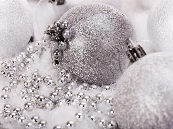 Christmas ball and beads in snow. — Stock Photo, Image