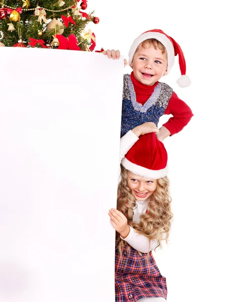 Kid with banner near Christmas tree. — Stock Photo, Image