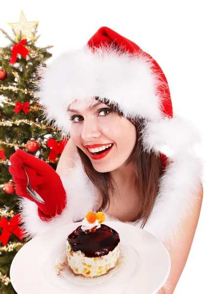 在吃蛋糕的圣诞老人帽子圣诞女孩. — 图库照片