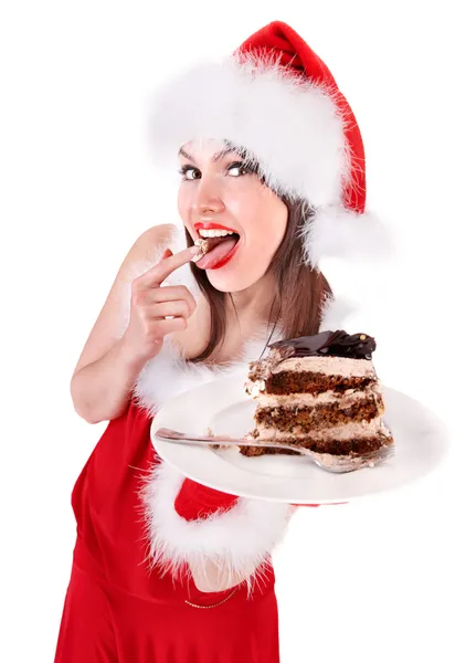 Mädchen mit Weihnachtsmütze essen Kuchen . — Stockfoto