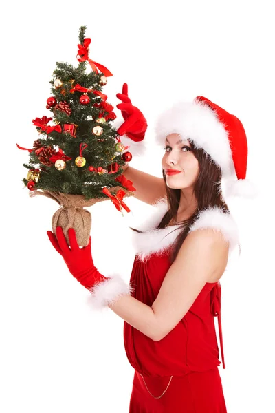 Flicka i santa hatt hålla julgran. — Stockfoto