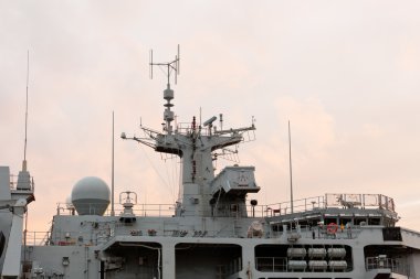 Sunset behind Royal Navy warship clipart