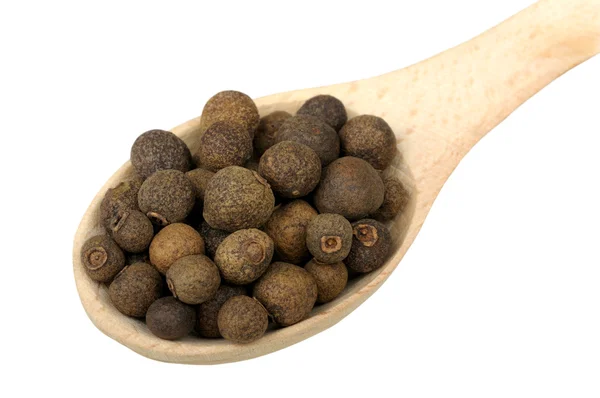 Allspice in a wooden spoon — Stock Photo, Image