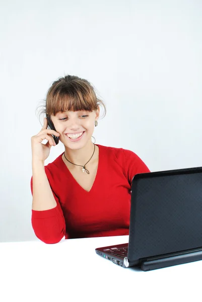 Young woman sitting at desk — Stock Photo, Image
