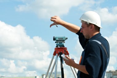 Surveyor works with theodolite clipart