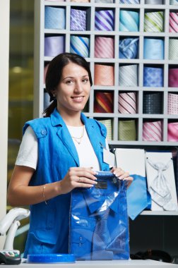 Young salesperson girl at clothes shop clipart