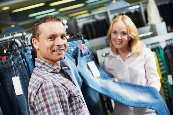 Young couple at clothes shopping — Stock Photo, Image