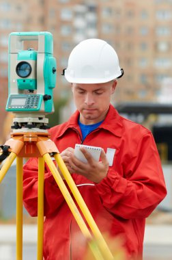 Surveyor works with theodolite clipart