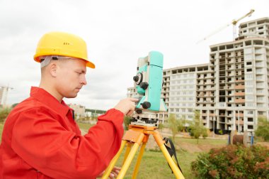 Surveyor works with theodolite clipart