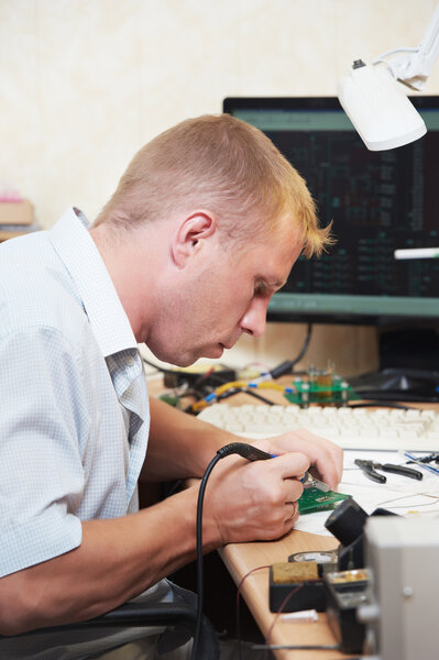Worker soldering microchip scheme