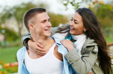 Two smiling young students outdoors