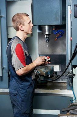 Worker at machining tool workshop clipart