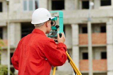 Surveyor works with theodolite clipart