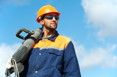 Portrait of construction worker with perforator clipart