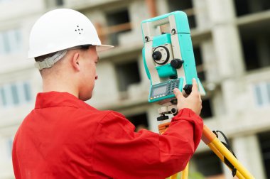 Surveyor works with theodolite clipart