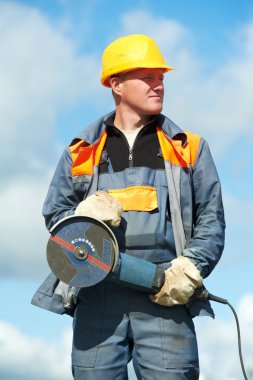 Portrait of construction worker with grinder clipart