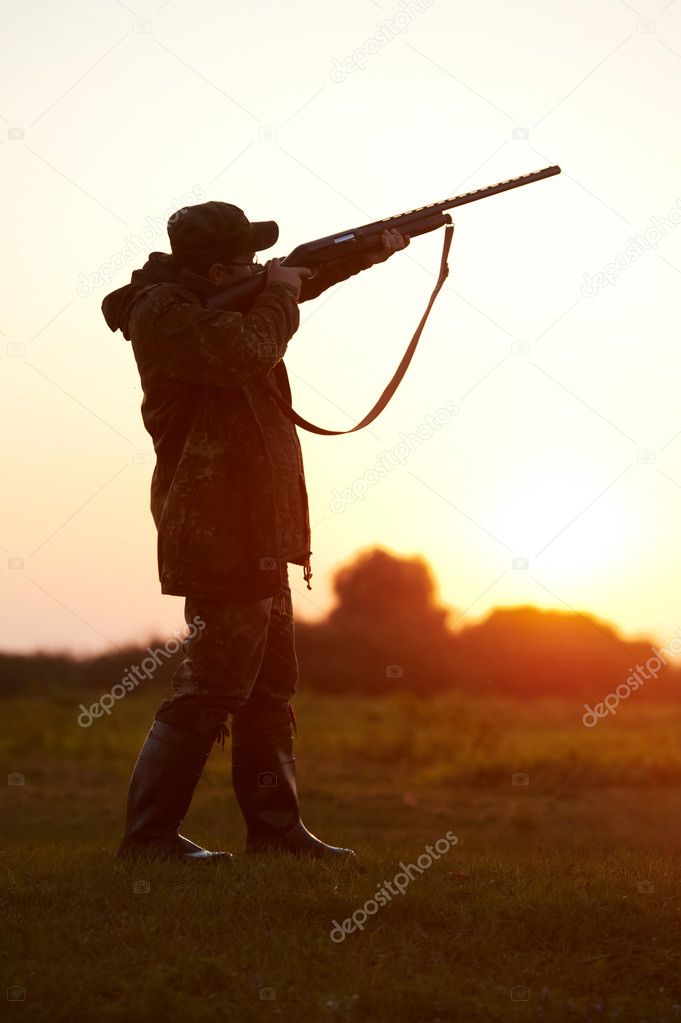 Hunter aiming with rifle gun