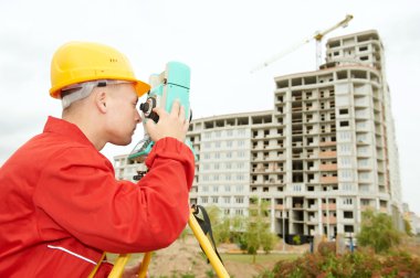 Surveyor works with theodolite clipart