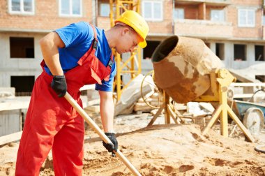 Builder worker at construction site with shovel clipart