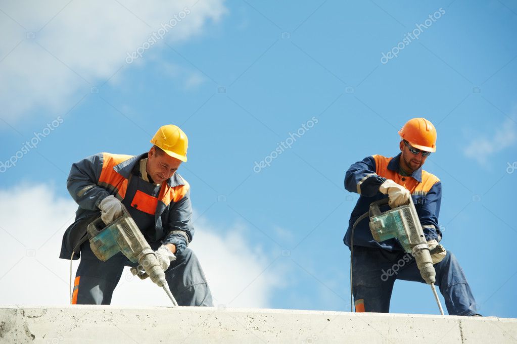 Construction workers with perforator
