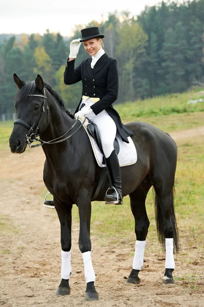 Horsewoman jockey in uniform with horse — Stock Photo, Image