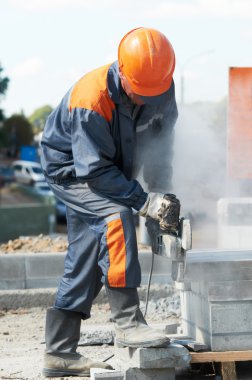 Builder at cutting curb work clipart