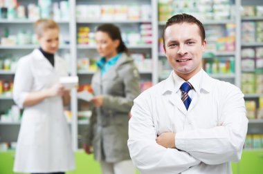 Confident pharmacy chemist man in drugstore clipart