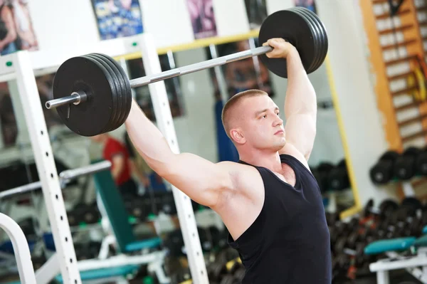 Bodybuilder lifting weight at sport gym — Stock Photo, Image