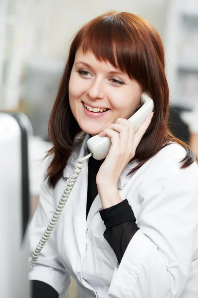 Pharmacy chemist woman in drugstore with phone — Stock Photo, Image