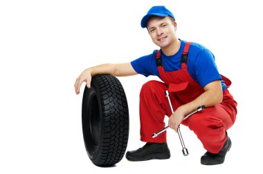 Automobile mechanic with car tire and spanner clipart