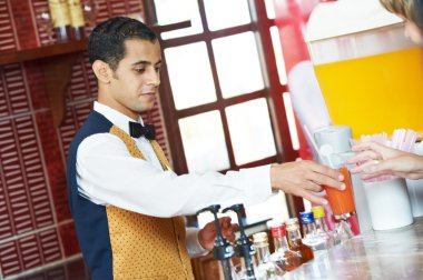 Cheerful arab barman at counter clipart