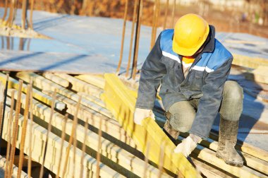 Construction worker preparing formwork clipart