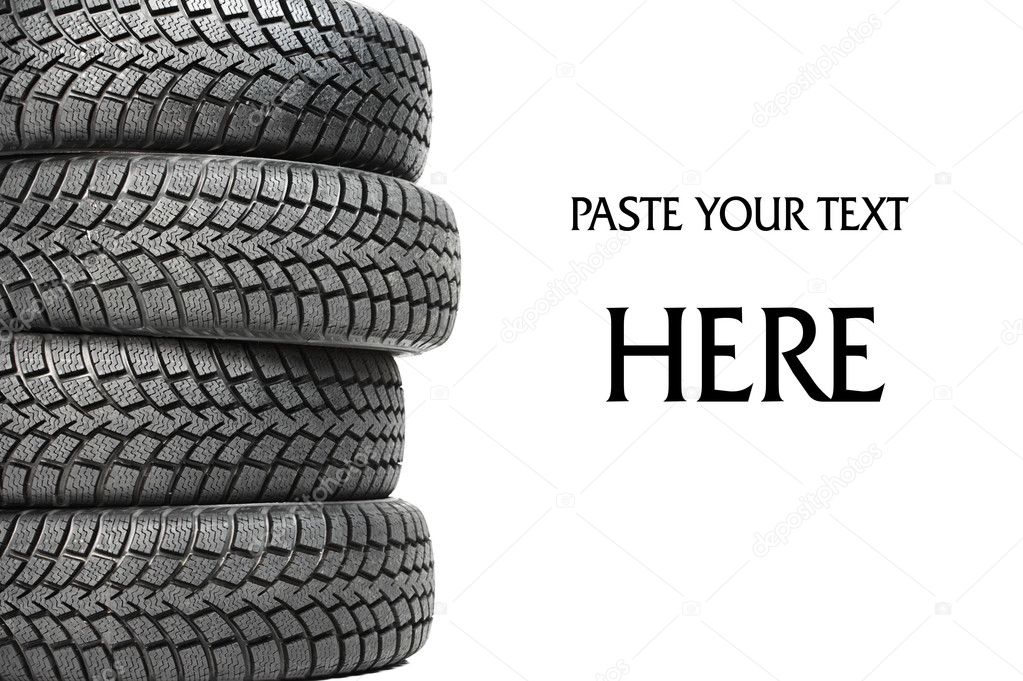 Stack of four car wheel winter tires isolated