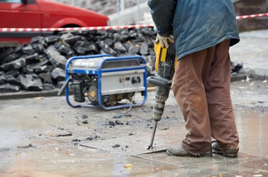 Construction worker with perforator clipart