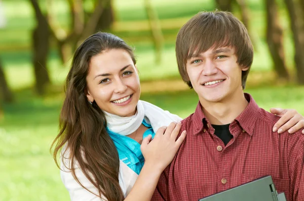 Två leende unga studenter utomhus — Stockfoto