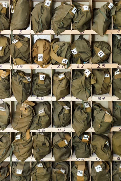 Background from folded gas masks in cells. Numbered and ready for use — Stock Photo, Image