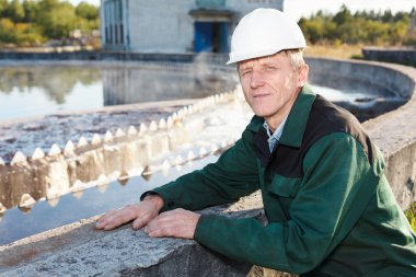 Mature man manual worker in white hardhat clipart