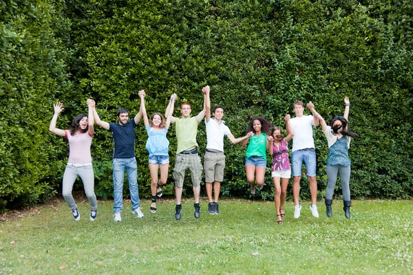 Happy Teenage College Students Jumping at Park — Stock Photo, Image