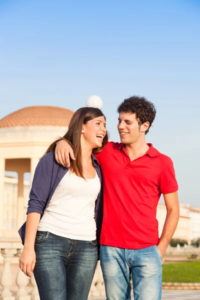 Happy Young Couple Walking Embraced Royalty Free Stock Images