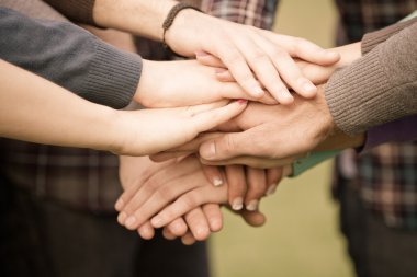 Multiracial Students with Hands on Stack clipart