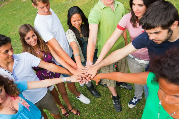 Happy Teenage Group with Hands on Stack — Stock Photo, Image
